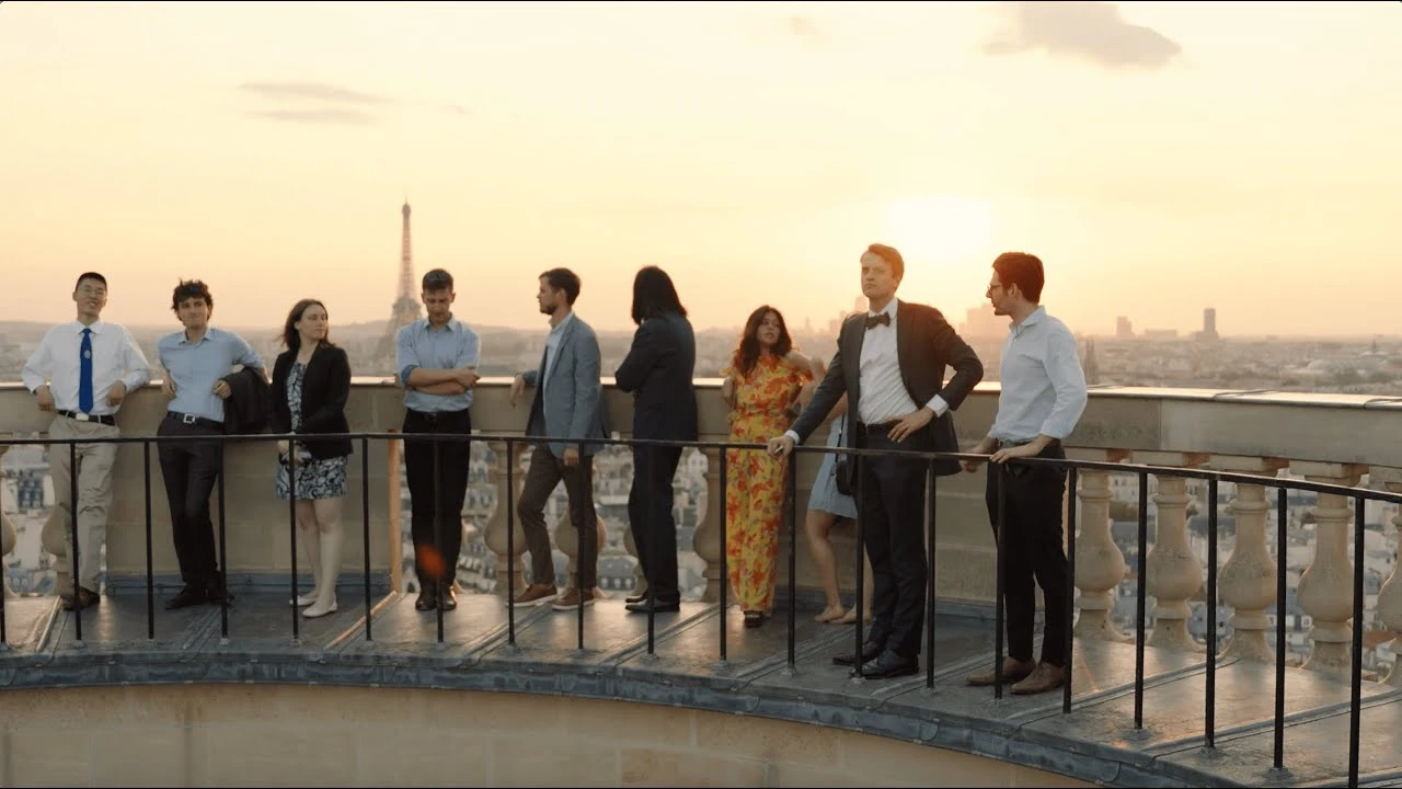 Academia Tocqueville 2023 fellows on a Paris rooftop facing the Eiffel Tower