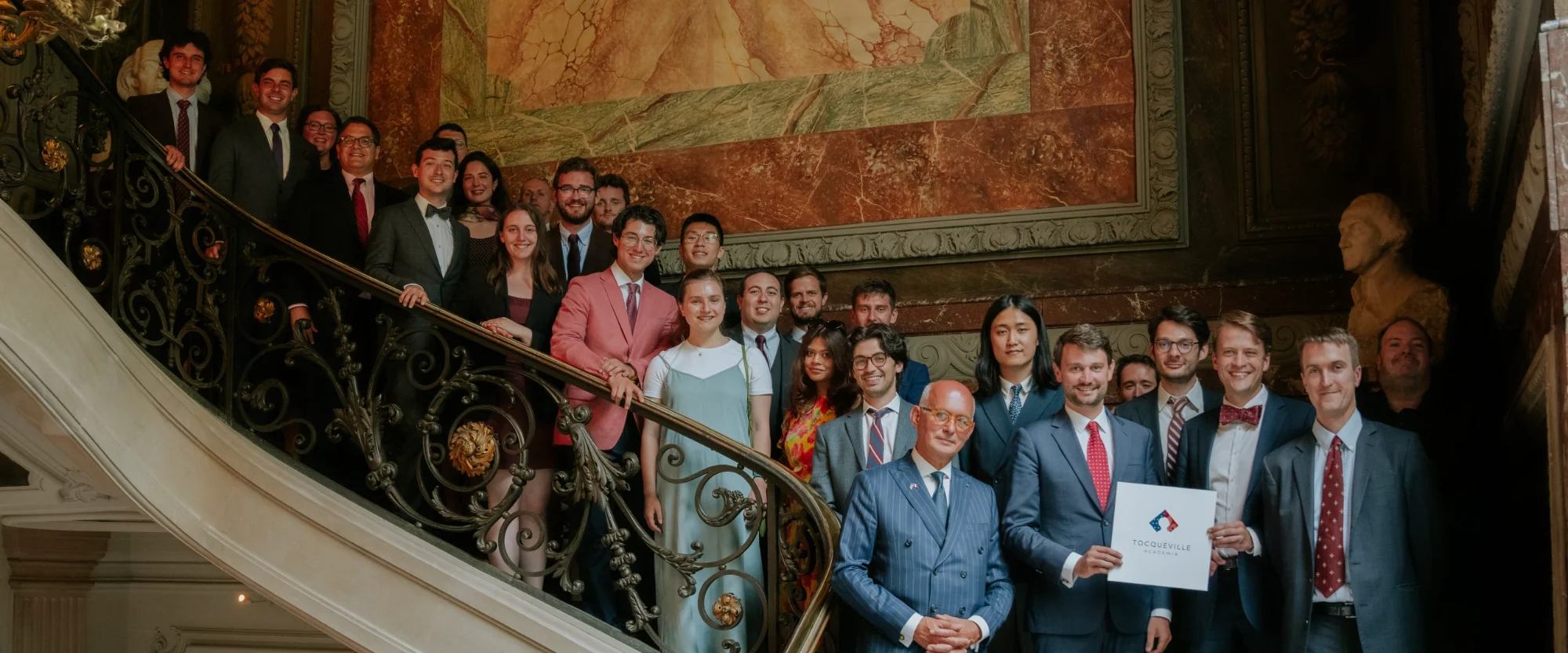 Academia Tocqueville fellows and faculty on a grand staircase